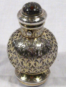 Appraisal: A silver gilt perfume bottle with a vinaigrette base and