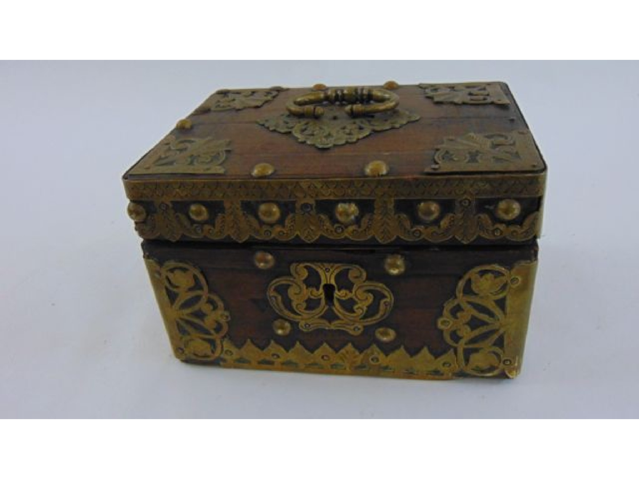 Appraisal: An Eastern hardwood casket overlaid with brass panels escutcheon and