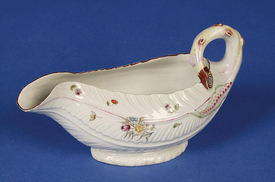 Appraisal: A FIRST PERIOD WORCESTER POLYCHROME LEAF MOULDED SAUCEBOAT circa the