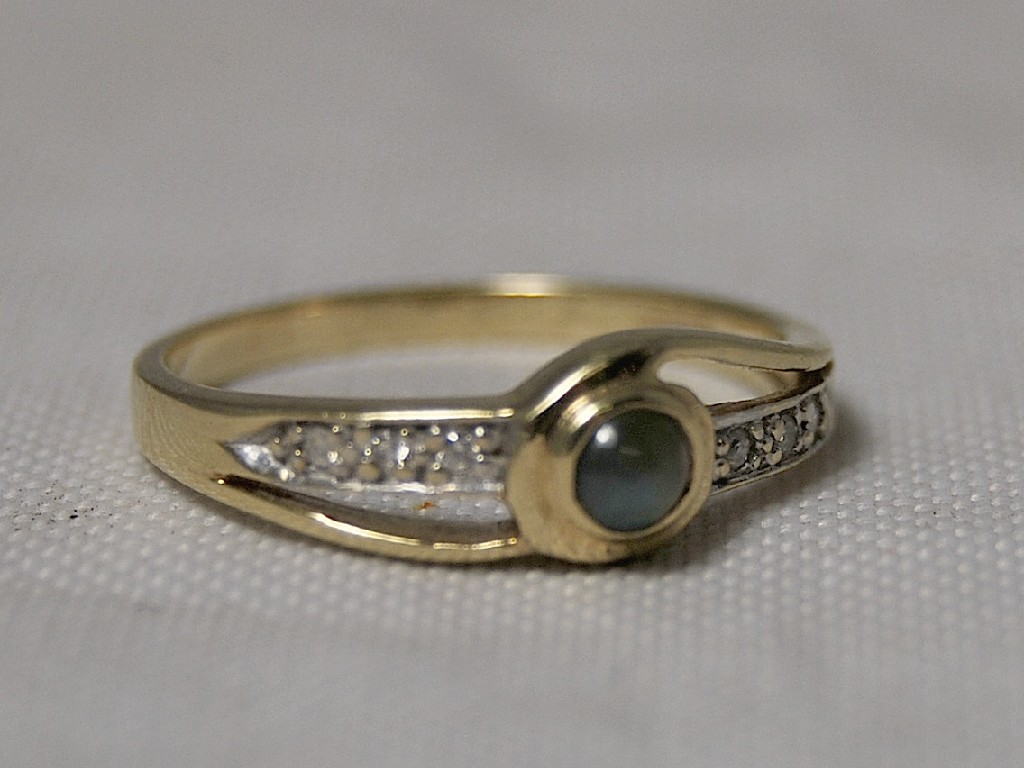 Appraisal: A ct gold ring set with moonstone and small diamonds