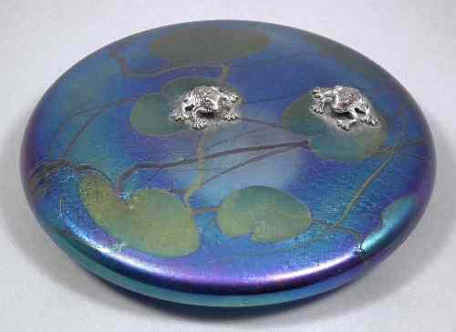 Appraisal: A John Ditchfield Glasform iridescent glass circular paperweight of flattened