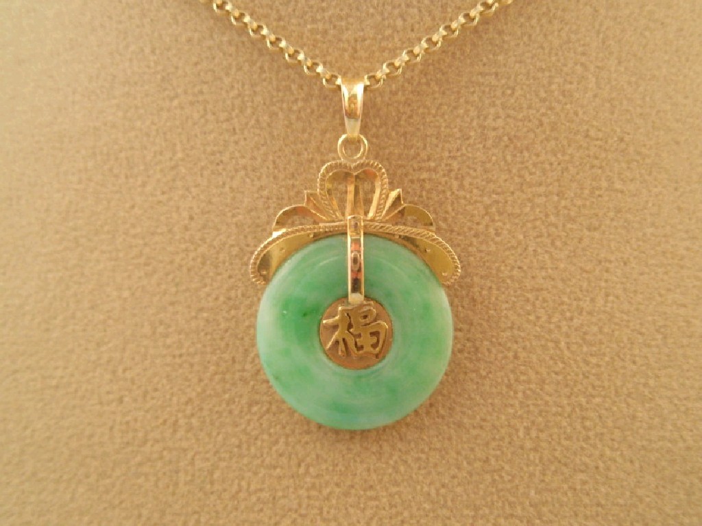 Appraisal: An oriental doughnut pendant and chain stamped g all in