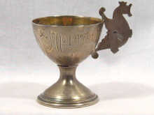 Appraisal: A Russian silver egg cup with pan slavic chicken handle