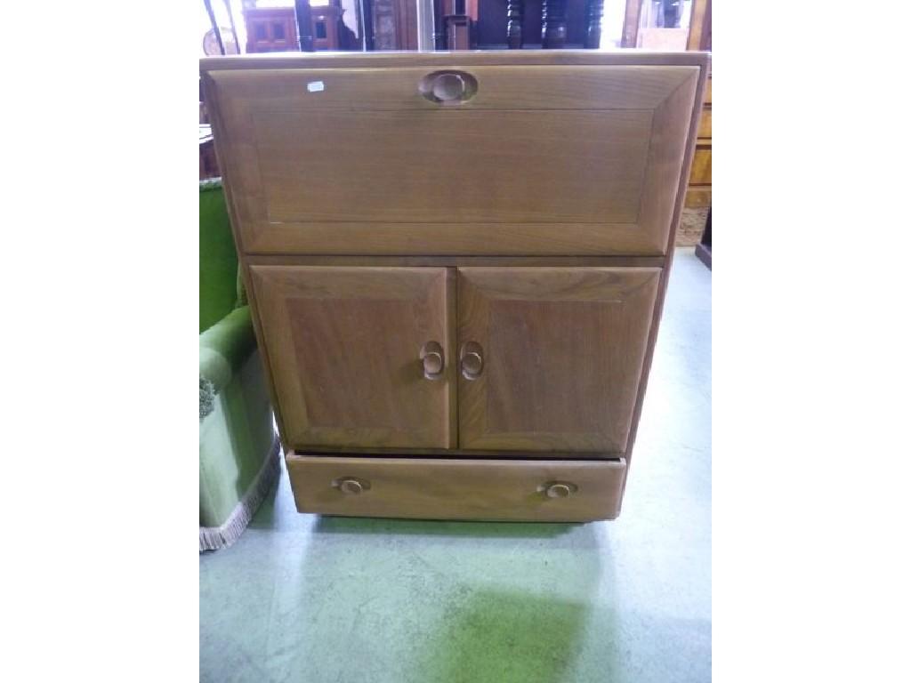 Appraisal: An Ercol light elm side cabinet with full front over