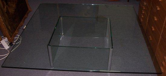 Appraisal: A large glass coffee table with square top on square