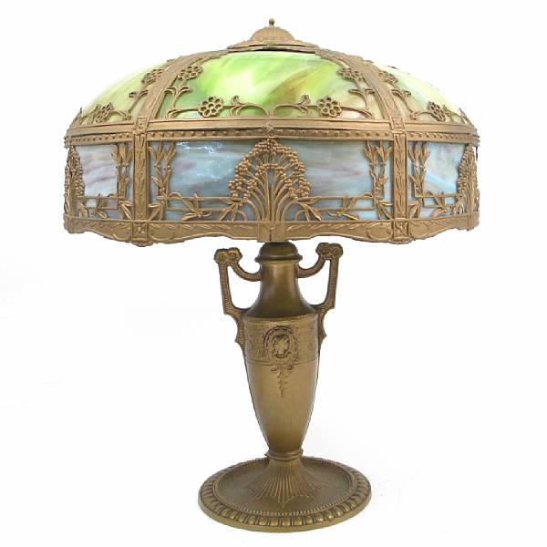 Appraisal: An American gilt-metal and slag glass lamp raised on an