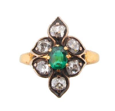 Appraisal: A diamond and emerald cluster ring Centred with an oval