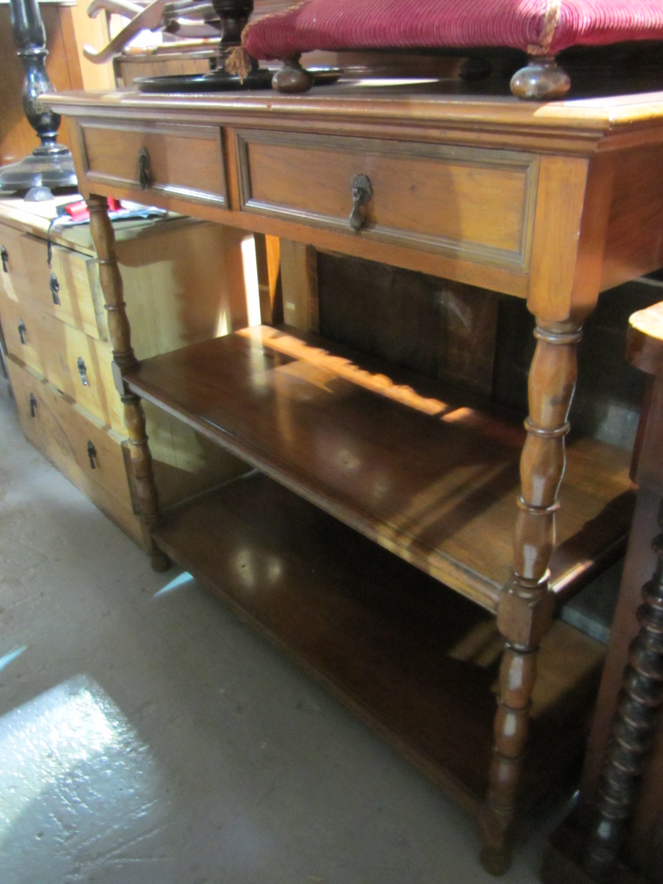 Appraisal: A th century mahogany three tier buffet