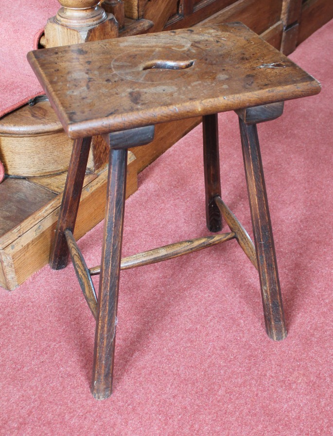 Appraisal: A thC rustic oak and elm stool with pierced handle