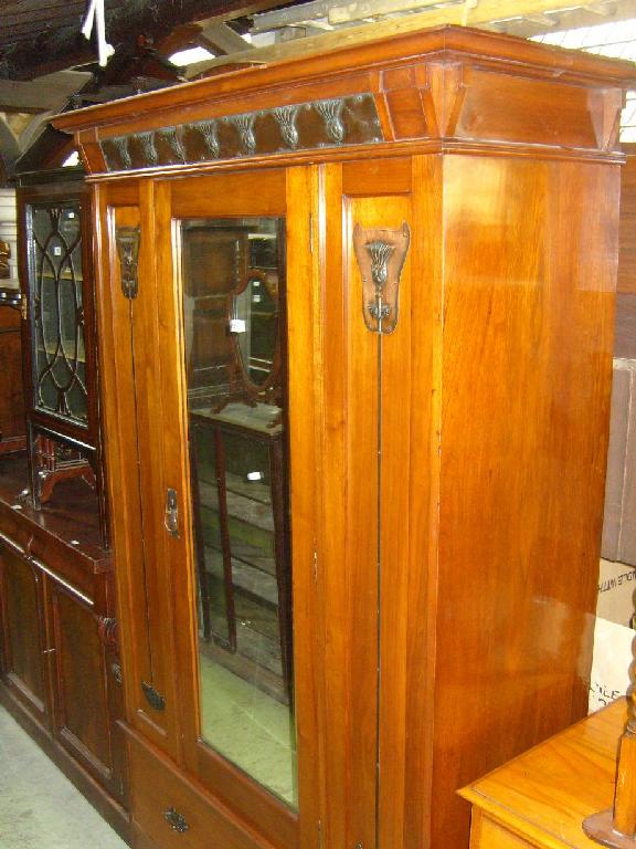 Appraisal: A walnut wardrobe enclosed by a single mirror panelled door