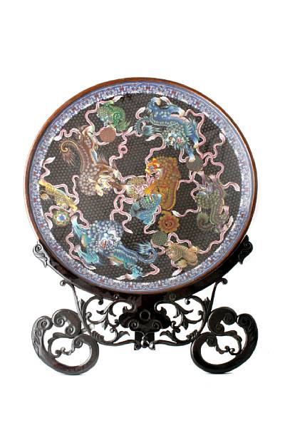 Appraisal: A large cloisonne enameled metal charger with lion dogs chasing