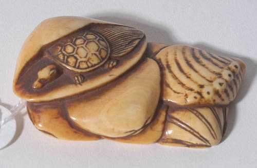 Appraisal: NETSUKE Japan th th century L cm Ivory with honey-coloured