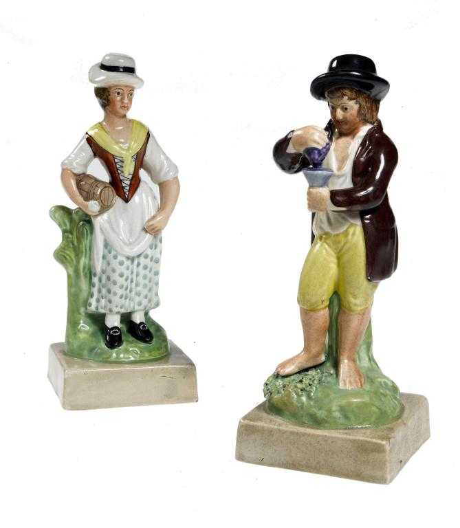 Appraisal: A PAIR OF STAFFORDSHIRE PEARLWARE FIGURES the barefoot youth holding