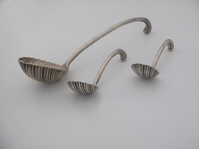 Appraisal: A George II soup ladle and a pair of sauce