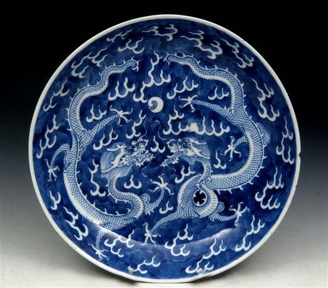 Appraisal: A CHINESE BLUE AND WHITE SAUCER DISH decorated dragons amongst