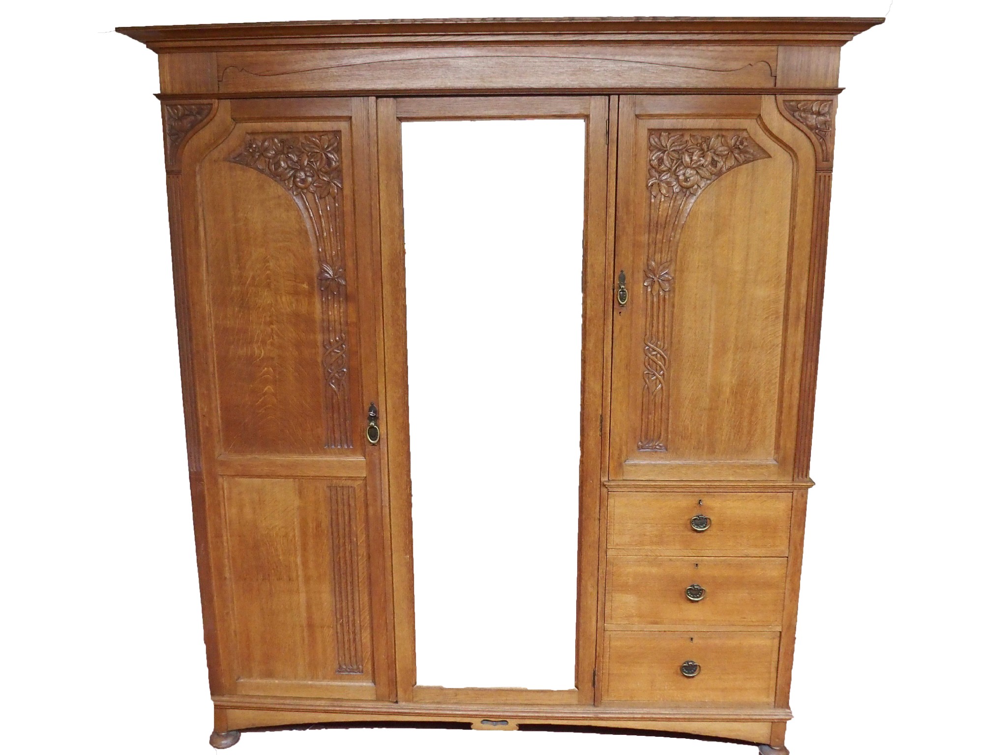 Appraisal: An oak Arts and Crafts three door wardrobe dressing table