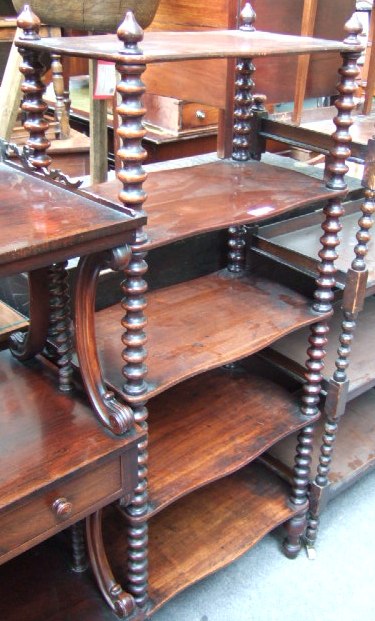 Appraisal: A Victorian mahogany what-not of five serpentine tiers raised on