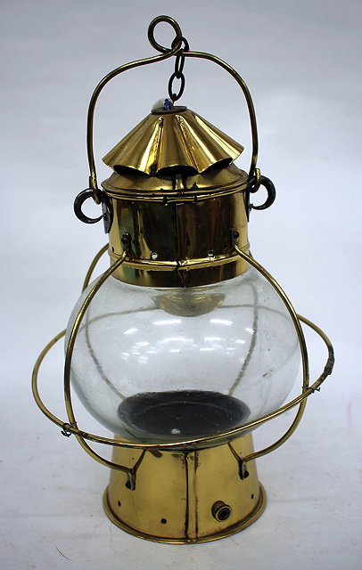 Appraisal: AN OLD BRASS SHIPS LANTERN with spherical glass shade later