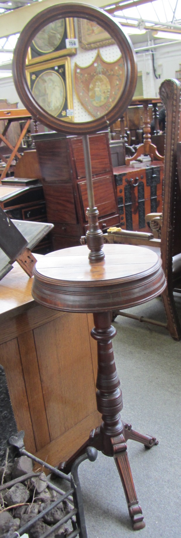 Appraisal: A Victorian oak shaving stand with circular mirror over twin