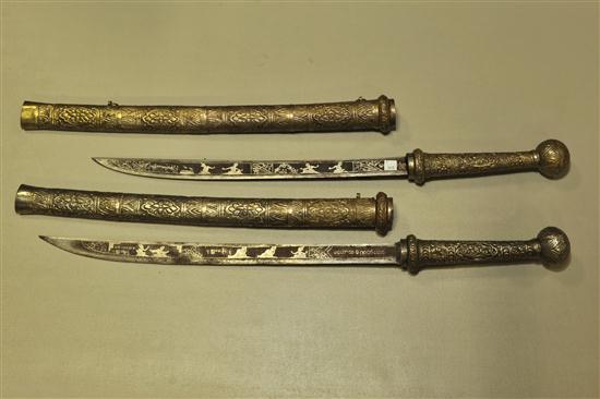 Appraisal: TWO DHA SWORDS Inlaid blades and metal sheaths with wood