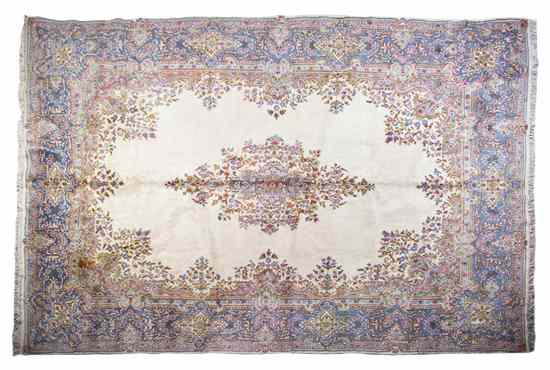 Appraisal: A Kirman Wool Rug having a diamond form center medallion