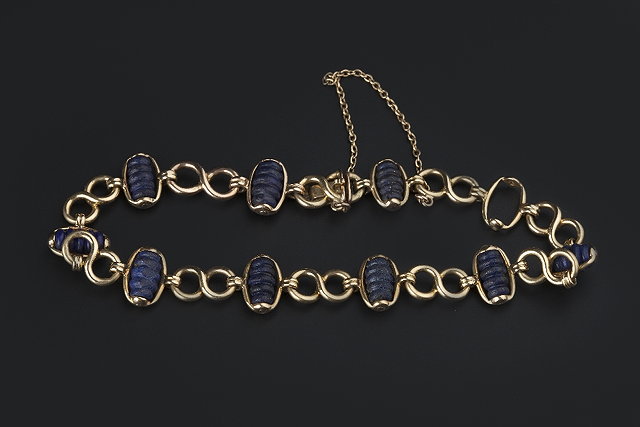 Appraisal: A LAPIS LAZULI SET BRACELET composed of figure-of-eight shaped panel