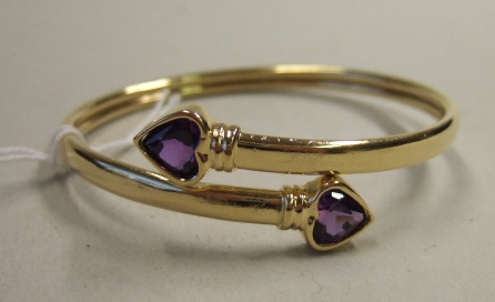 Appraisal: A gold and mauve gem set bangle of circular form