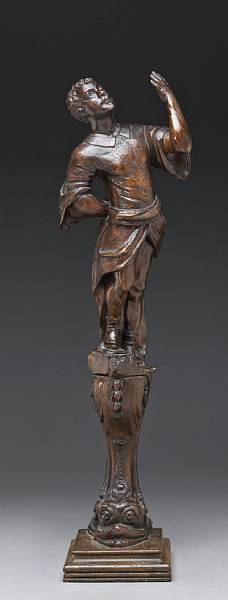 Appraisal: An Italian carved walnut blackamoor figure on associated dolphin support