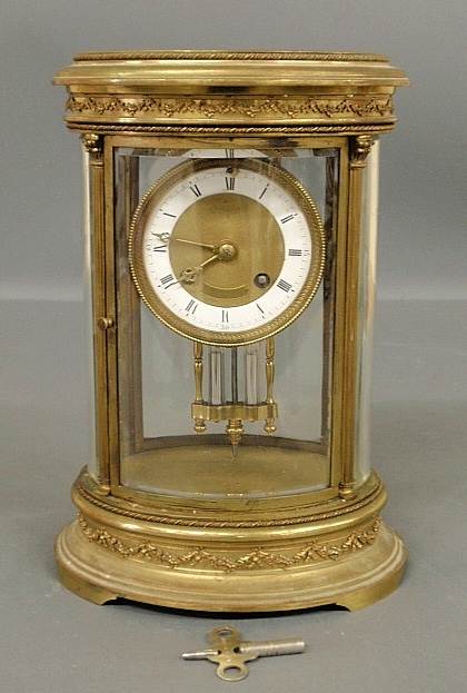 Appraisal: - French brass and beveled glass mantle clock with porcelain