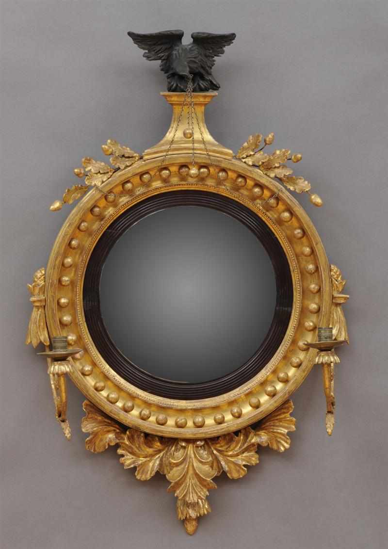 Appraisal: REGENCY CARVED EBONIZED AND GILTWOOD CONVEX GIRANDOLE MIRROR The plate