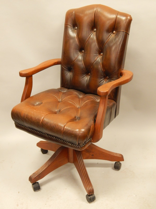 Appraisal: A stained pine Ducal office chair upholstered in brown button