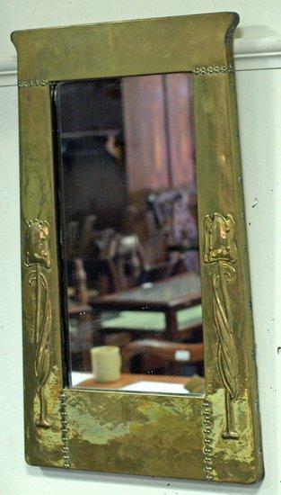 Appraisal: An Art Nouveau brass mirror the frame embossed stylised flowers