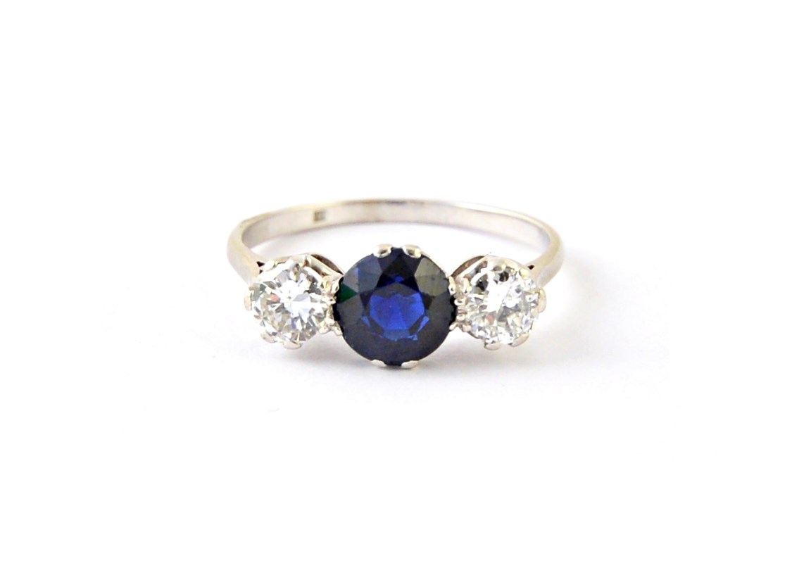 Appraisal: A platinum diamond and sapphire set three stone ring claw