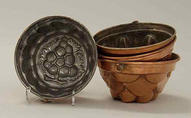 Appraisal: FOUR ANTIQUE AMERICAN HAND-WROUGHT COPPER FOOD MOLDS th CenturyAll differing