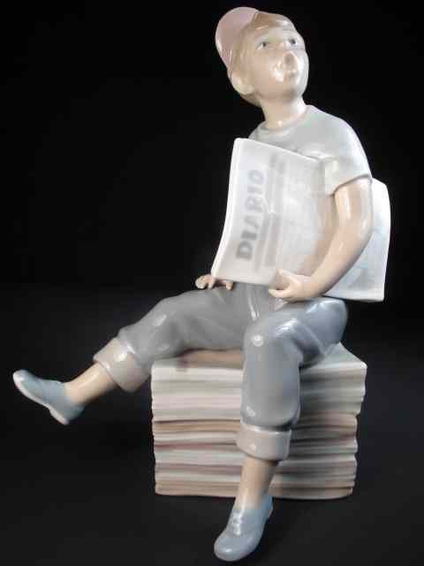 Appraisal: Lladro porcelain figurine depicting a boy sitting on a stack