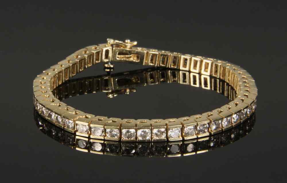 Appraisal: BRACELET - One K yellow gold diamond tennis bracelet channel