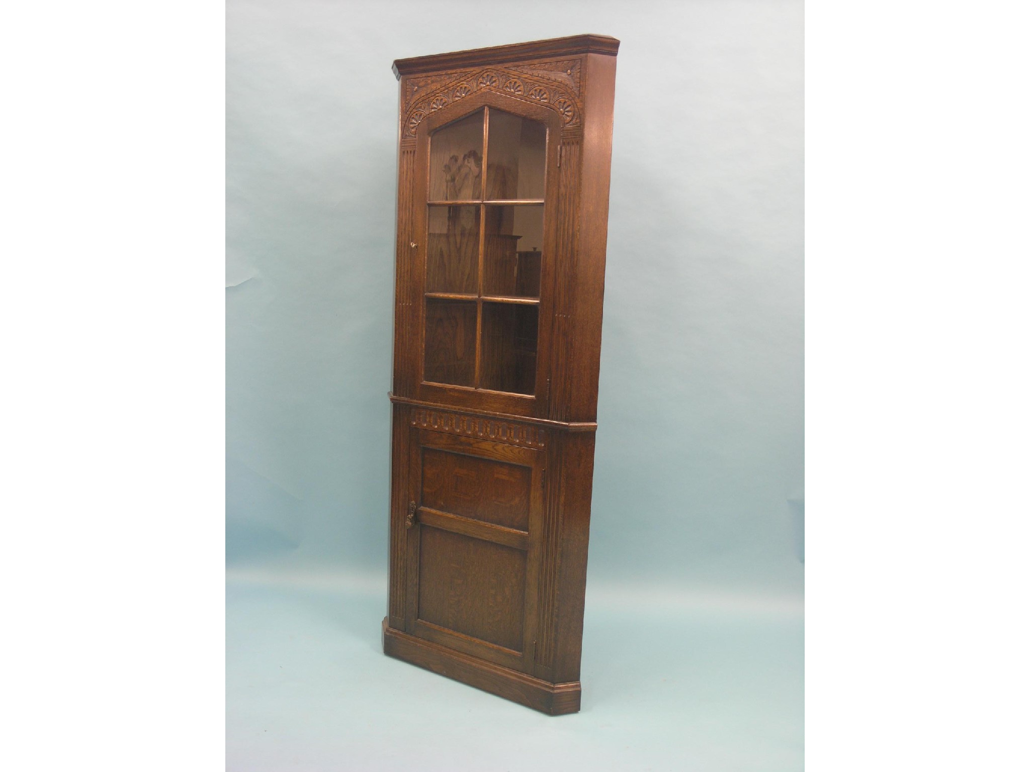 Appraisal: A solid dark oak corner cabinet floor-standing glazed upper door