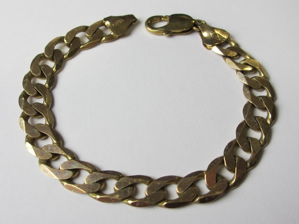 Appraisal: A nine carat gold flat curb link bracelet Approximately grams