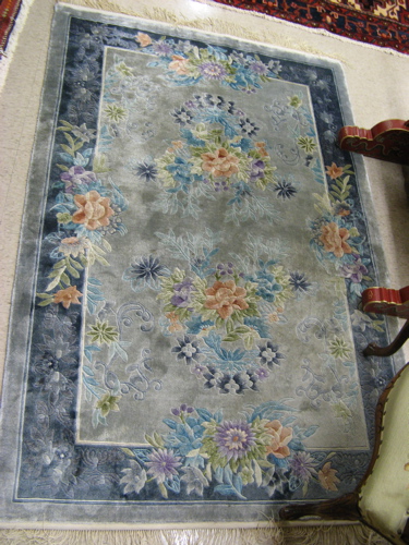 Appraisal: CHINESE SILK AREA RUG hand knotted in an overall floral