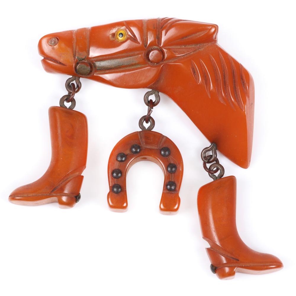 Appraisal: BAKELITE EQUESTRIAN HORSE HEAD PIN BROOCH WITH COWBOY BOOT AND