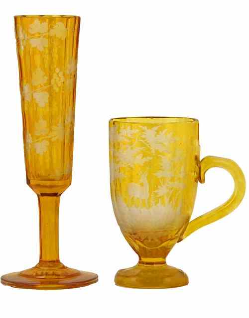 Appraisal: A pair of Bohemian amber glasses of slender tapering form