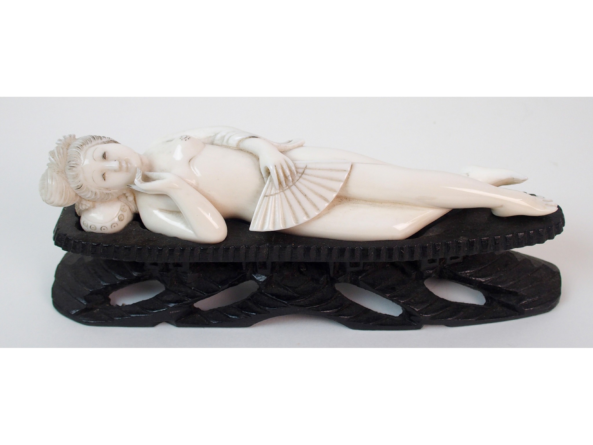 Appraisal: A Burmese ivory doctor's dollon stand the naked female reading