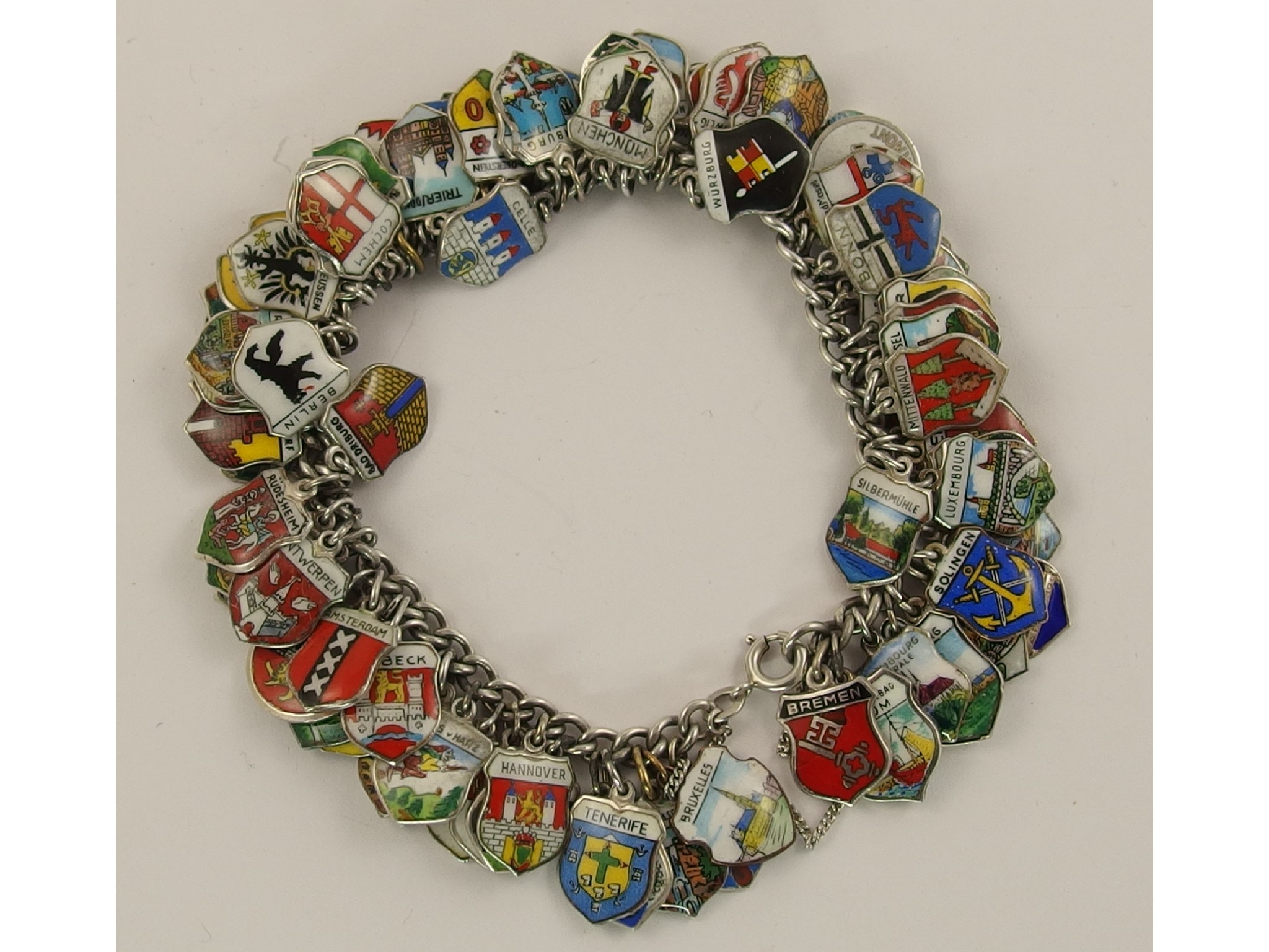 Appraisal: A silver charm bracelet hung with many enamelled place name