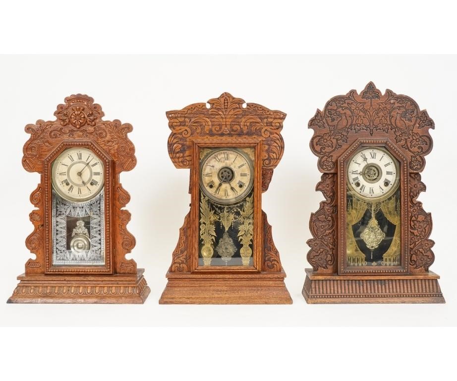 Appraisal: Three gingerbread oak mantel clocks by Ansonia and two by