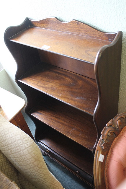 Appraisal: A REPRODUCTION MAHOGANY WATERFALL OPEN BOOKCASE with one drawer cm