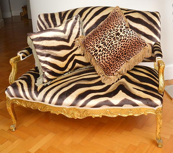 Appraisal: A CARVED AND GILT WOOD FRAMED SETTEE WITH FAUX ZEBRA