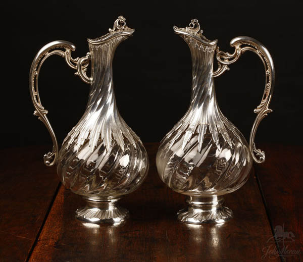 Appraisal: Near-pair French sterling glass claret jugs Near-pair French sterling glass