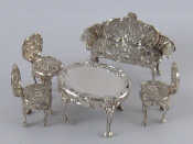 Appraisal: A miniature silver salon set of sofa three chairs and