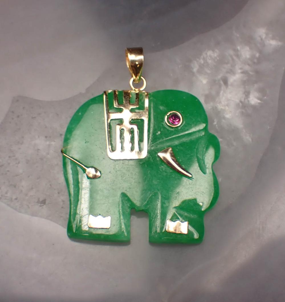 Appraisal: JADE RUBY AND FOURTEEN KARAT GOLD PENDANT The green jade