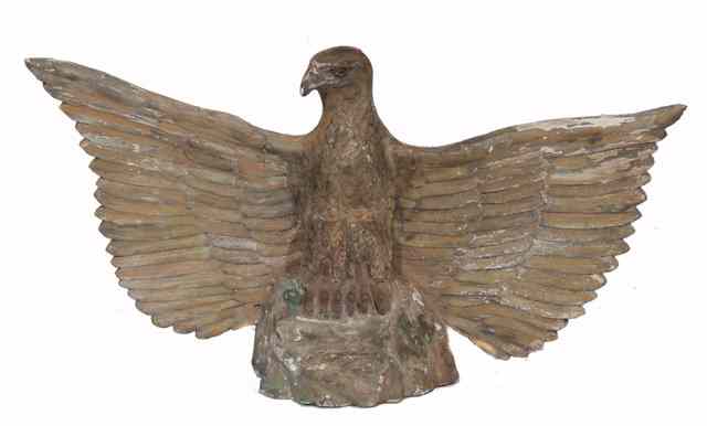 Appraisal: A LARGE CARVED GILT WOODEN EAGLE perched on a rocky